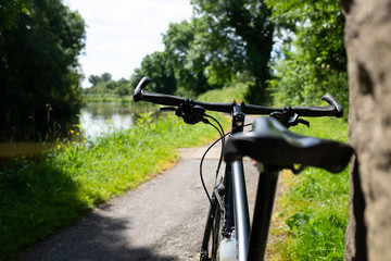 Fototapeta na wymiar bicycle on the canal towpath summer sunshine