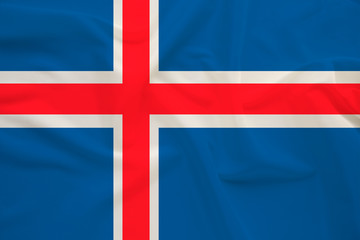 Fototapeta premium national flag of the country iceland on delicate silk with creases from the wind, concept of travel, immigration, politics, copy space, close-up