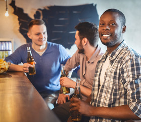 Friends watching football match at bar together