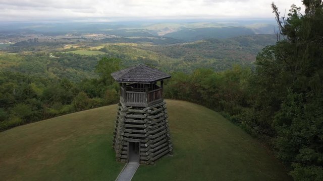 Closeup aerial orbit low and to the left showing the overlook tower at Droop Mountain State Park in West Virginia.