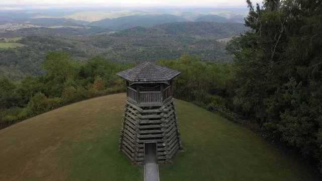 Aerial camera descending slowly and pitching up onto the overlook tower at Droop Mountain State Park in West Virginia.
