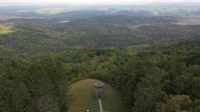 Aerial orbit high and to the left showing the overlook tower at Droop Mountain State Park.
