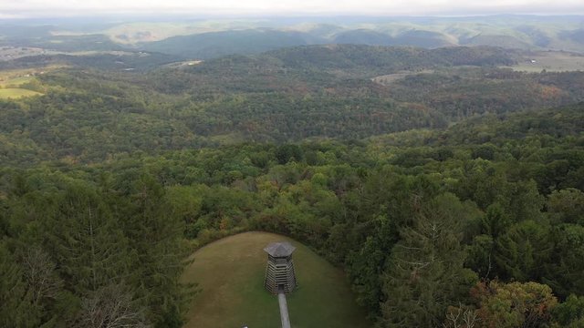 Aerial orbit high and to the right showing the overlook tower at Droop Mountain State Park.