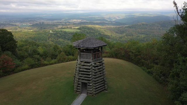Closeup aerial orbit low and to the right showing the overlook tower at Droop Mountain State Park in West Virginia.