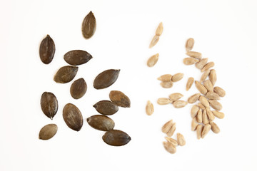 Pumpkin and sunflower seeds on white background