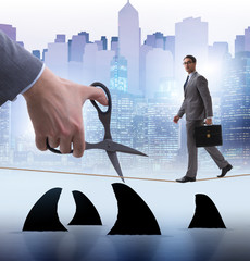 Obraz premium Hand cutting rope in business risk concept