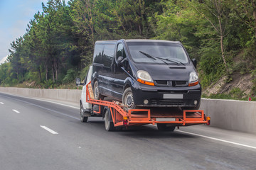 wrecker transports broken car