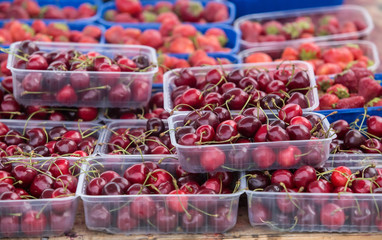 cherries in plastic trays on the counter