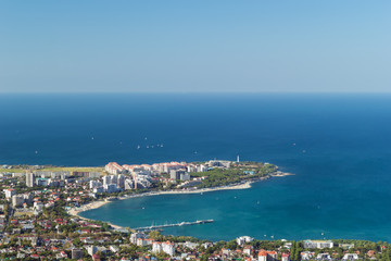 Naklejka premium Scenic view of Gelendzhik resort city district from hill of caucasian mountains. Sunny day in vacation. Background with copy space.