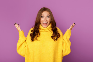 Young woman with surprised facial expression, purple background