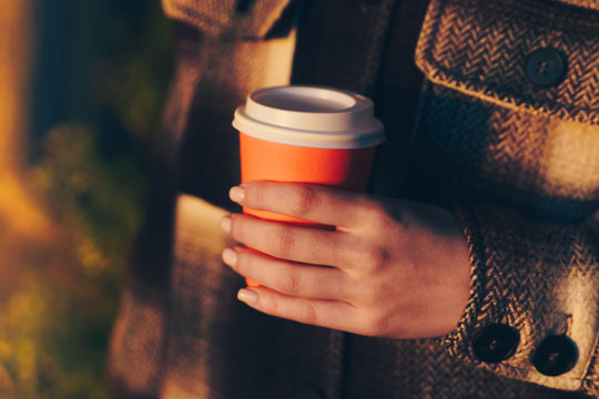 Close Up Of Woman Hands Holding A Cup Of Takeaway Coffee Cup. Paper Cup Coffee On The Go.