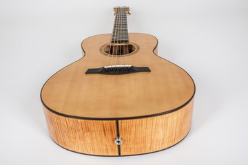 wood texture of lower deck of six strings acoustic guitar on white background. guitar shape
