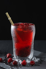 glass of refreshing raspberry cocktail with ice crumb 