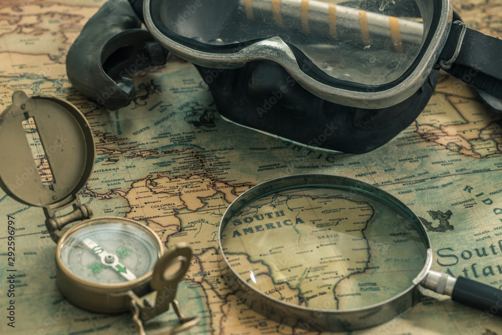 Aufkleber old map with a compass, notebook and diving equipment. The concept of searching for interesting diving sites or underwater treasures around the world