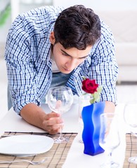 The man alone preparing for romantic date with his sweetheart