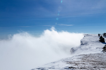 Snowy mountains above the clouds