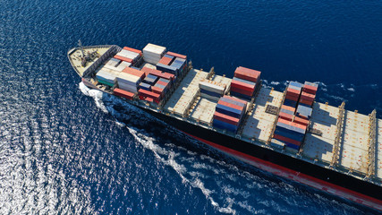 Aerial photo of large cargo container ship cruising the deep blue Mediterranean sea