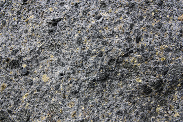 A volcanic stone background inlaid with green olivine