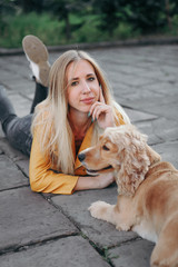 Young girl with dog walks in the park and enjoys the beautiful summer day.
