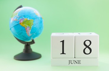 Planner wooden cube with numbers, 18 day of the month of June, summer