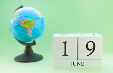 Planner wooden cube with numbers, 19 day of the month of June, summer
