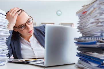 Tired businesswoman with paperwork workload