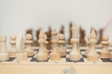 wooden chess on a chessboard. The concept of progress, investment, responsibility and risk in a financial game. checkmate