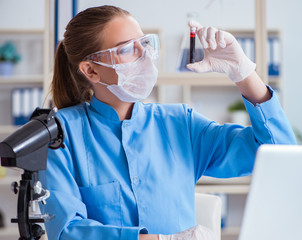Female scientist researcher conducting an experiment in a labora