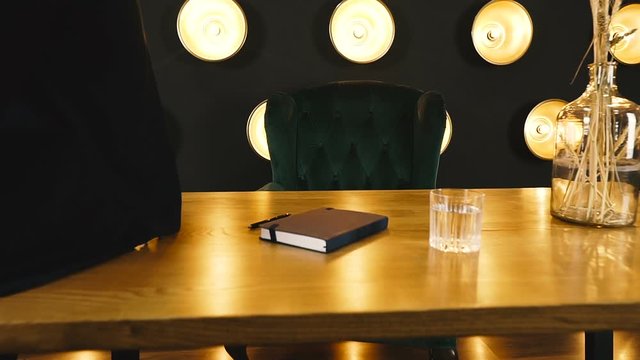 Office table. A man works at a wooden office table.