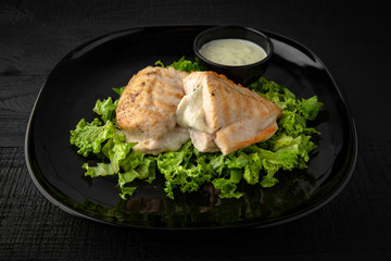 Grilled chicken fillet stuffed with mushrooms in a creamy sauce