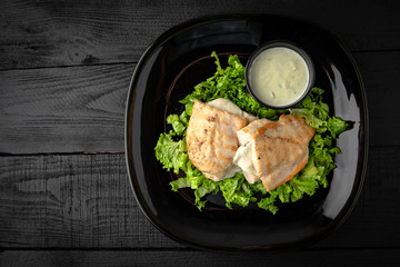 Grilled chicken fillet stuffed with mushrooms in a creamy sauce