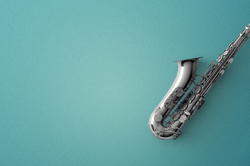 Saxophone on color background