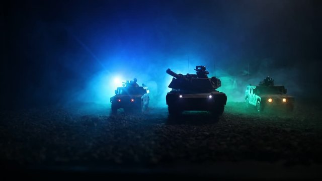 War Concept. Military silhouettes fighting scene on war foggy sky background at night. Armored vehicles with soldiers ready to attack. Artwork decoration. Selective focus