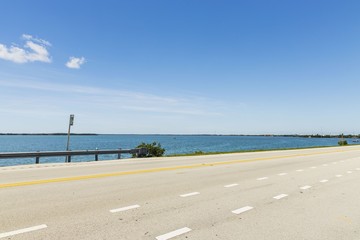 Beautiful view of nanural landscape. Asphalt highway to Key West, Florida on blue water of Atlantic...