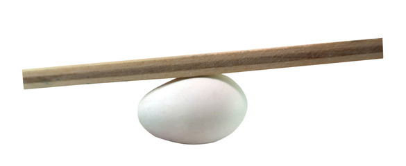 Balance concept, board on egg balance isolated on white background, balancing on seesaw in...
