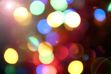 Fototapeta premium Abstract bokeh background, slightly blurry colored lights, festive city street