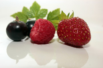 berry strawberry and raspberry with green leaves,  on white background.