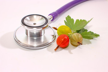Stethoscope for checking pulse on  white background, medical device. Thorny Red Gooseberry (Ribes...