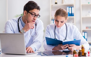 Male and female doctor having discussion in hospital