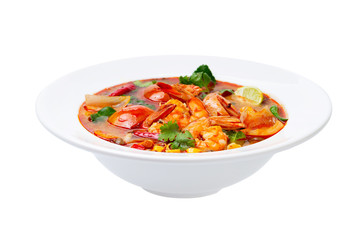 Closeup plate of traditional thai soup - tom yum kung with shrimps and tomatoes isolated at white background.