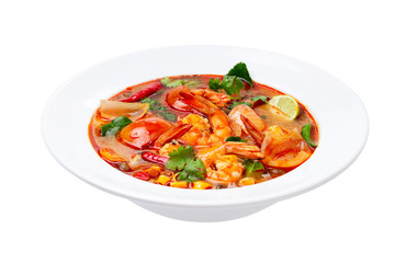 Closeup plate of traditional thai soup - tom yum kung with shrimps and tomatoes isolated at white background.