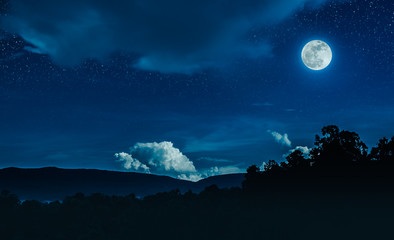 Landscape of blue night sky with many stars and beautiful full moon.