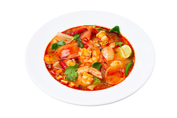 Closeup plate of traditional thai soup - tom yum kung with shrimps and tomatoes isolated at white background.