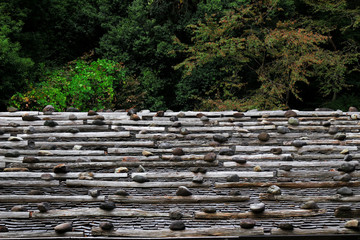 The roof of an old Japanese house made of tile, wood and stone