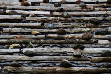 The roof of an old Japanese house made of tile, wood and stone