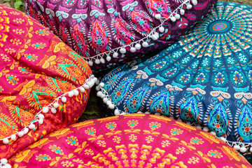 Fototapeta premium Bright colorful handmade ethnic traditional pillows background selling on a local asian market