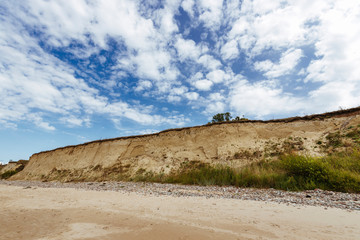 Rocky coast line of the Baltic sea in Latvia, during sunny summer day with blue sky.