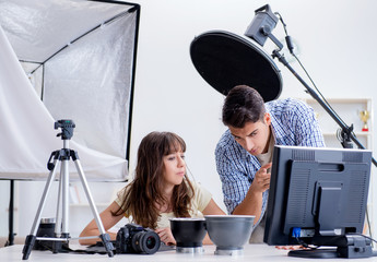 Young photographer working in photo studio