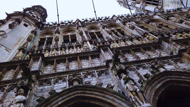Panorama of Gothic decorations of Brussels Town Hall building on cloudy day. Royalty free Full HD stock footage for Belgian and European travel, culture, architecture, 