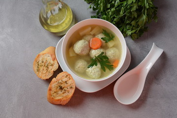 Low fat vegetable soup with chicken meatballs, potato and carrot and fresh herbs in bowl, Healthy food diet